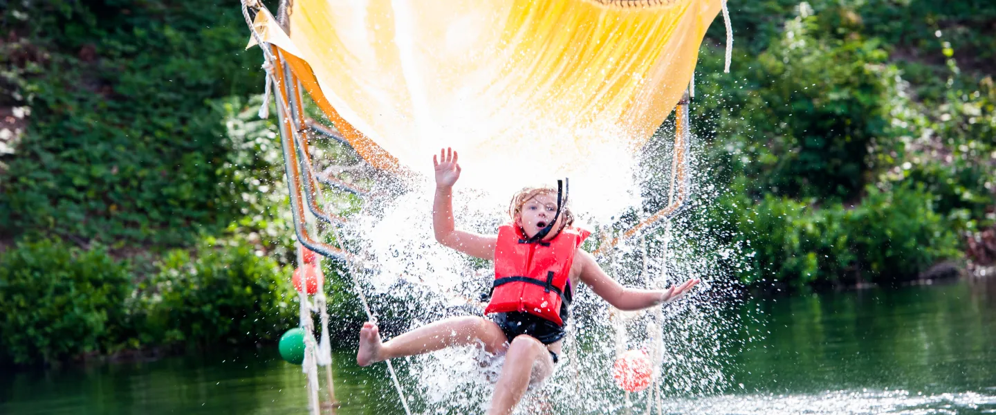 Child on Camp Hanes water zip line