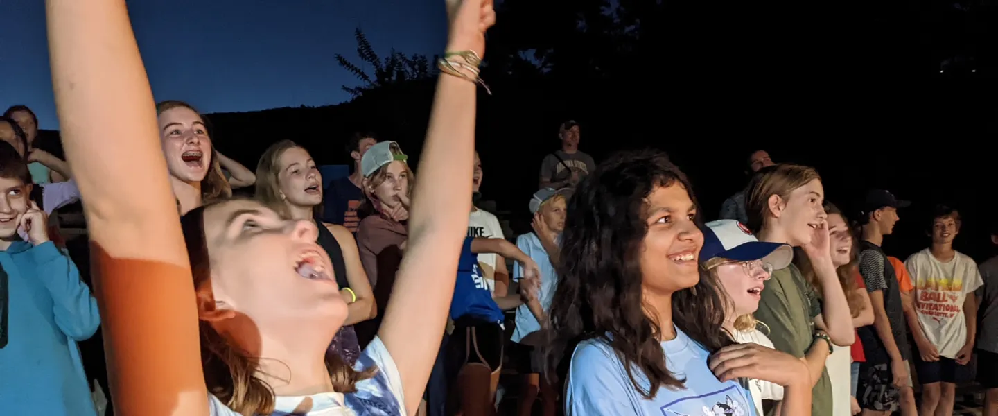 Kids laughing at camp fire