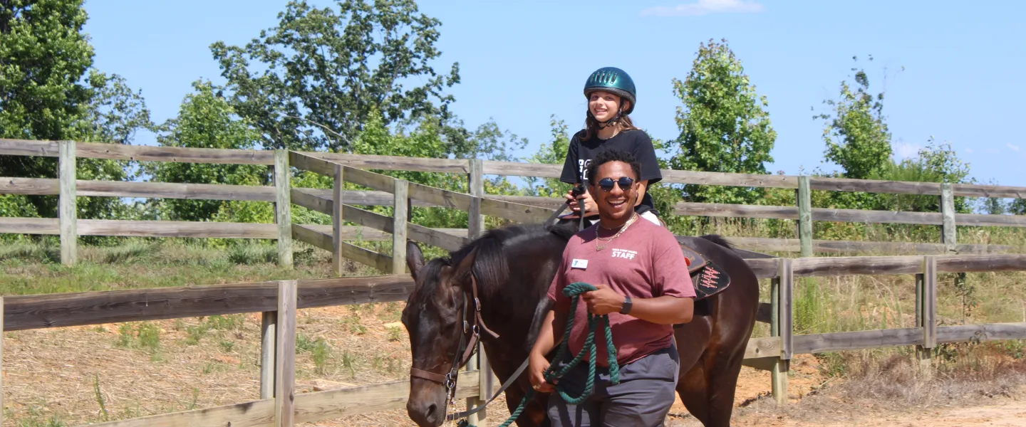 Child on horse with a staff leader