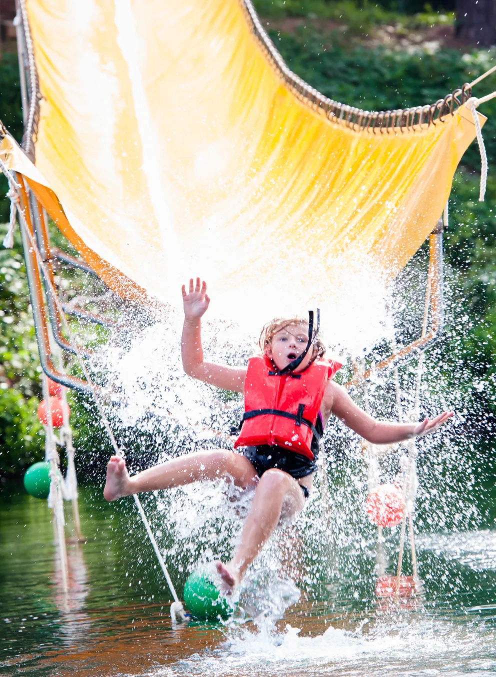 Child on Camp Hanes water zip line