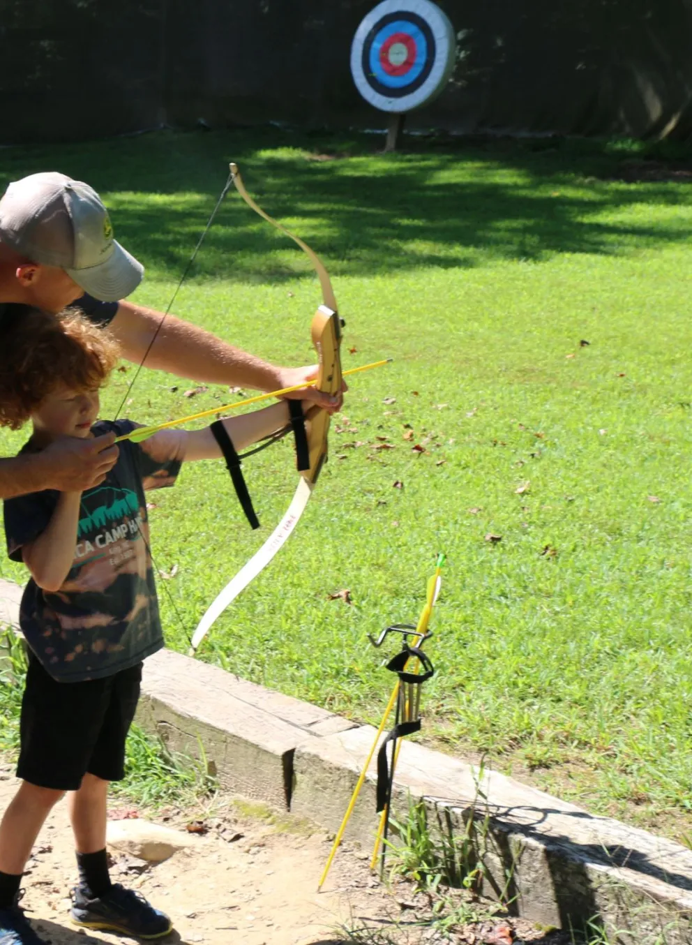 father and son shooting a bow and arrow
