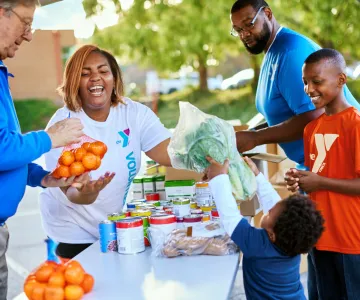 People handing food out to a family