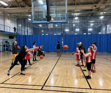 Kids lining up to pass a basketball