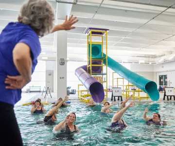 Older women taking a water fitness class