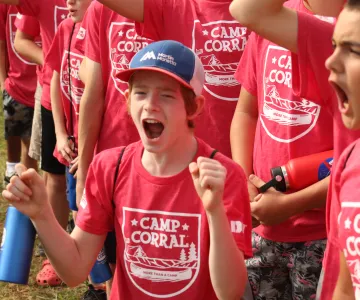 Two boys wearing camp corral shirts excitedly yelling.