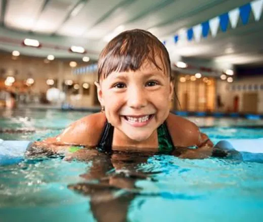 Girl in the pool smiling
