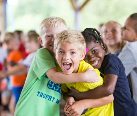 Kids hugging at summer camp