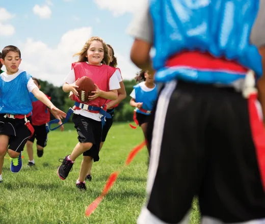Girls and boys playing flag football