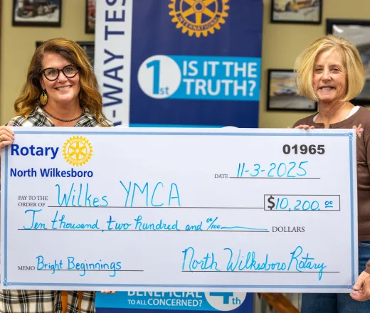 Caroline Whitson and Jenny Richardson presenting check